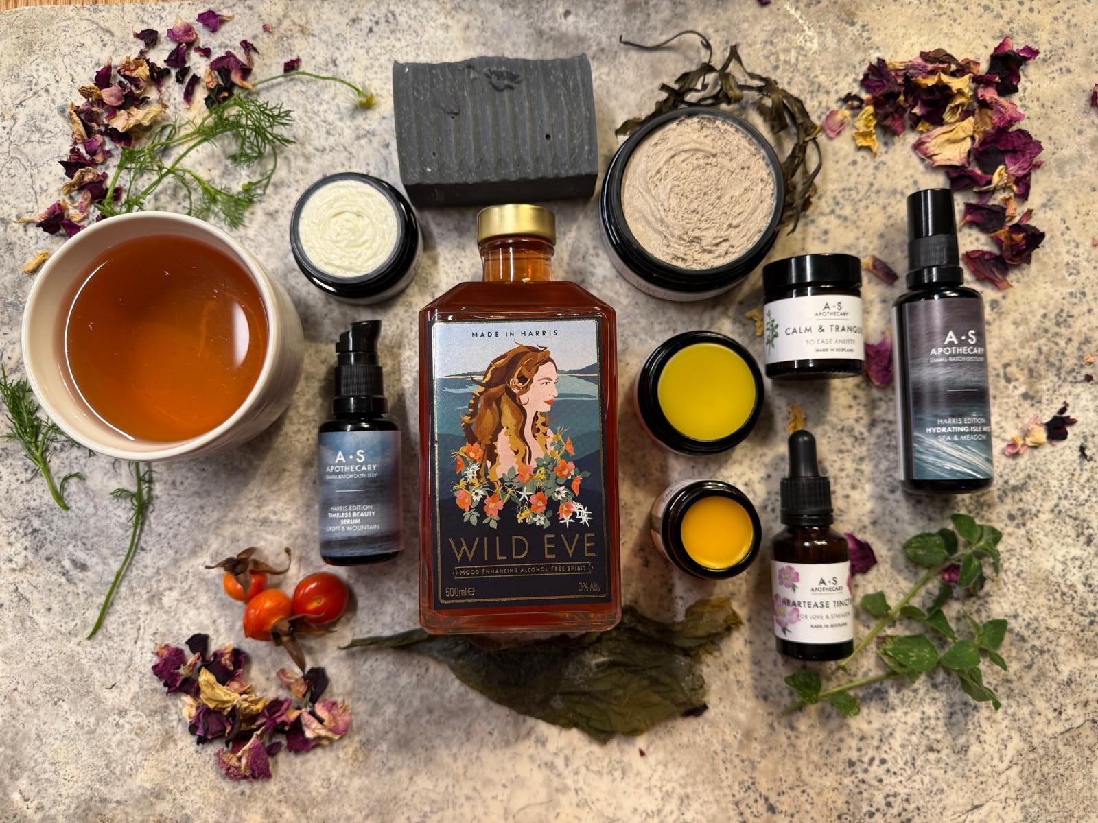 A.S Apothecarys products laid out on a flat surface. Skincare, soaps Wild Eve and teas